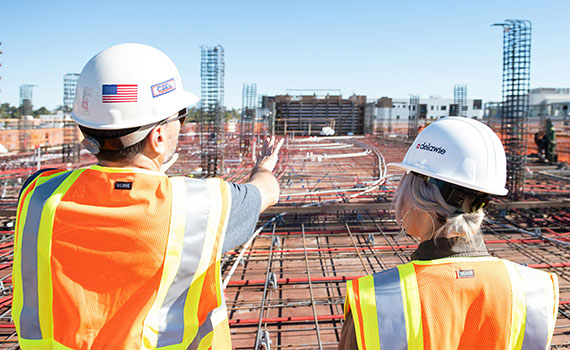 two people overlooking a construction site