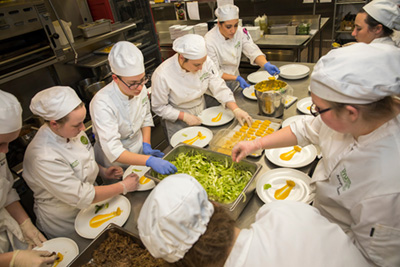 students preparing dishes