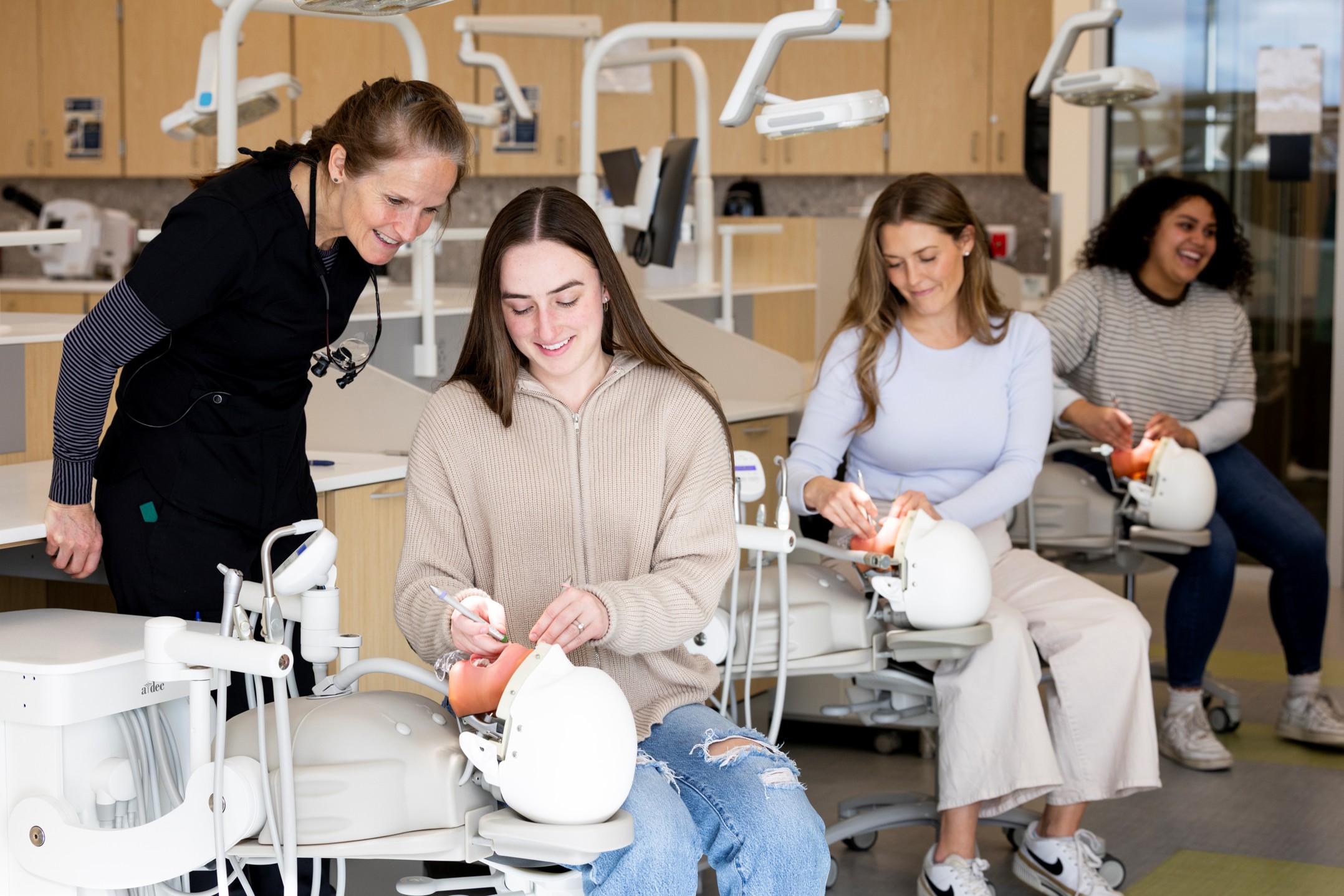 Dental Hygiene students in lab Dental Hygiene students in lab with instructor working on a manakin