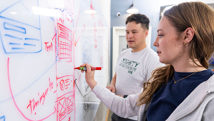 two students whiteboarding