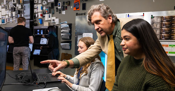 professor working with two students