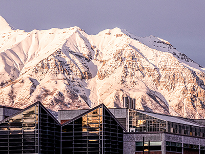 decorative image of campus with snow-covered mountains in the evening sun