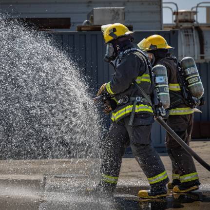 Firefighters practicing with firehose