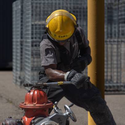 Fire Fighter practicing on a fire hydrant