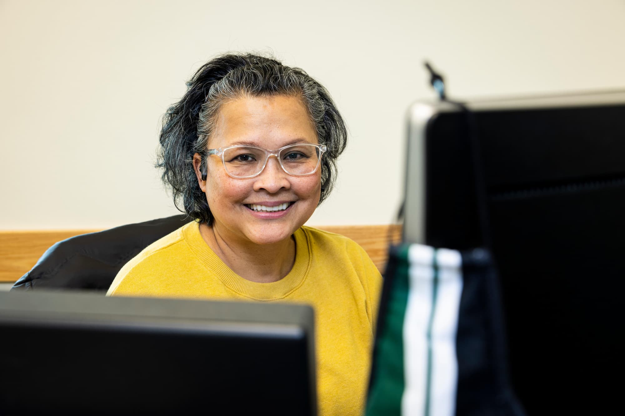 Women sitting at desk smiling