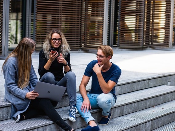 Students talk and laugh outside