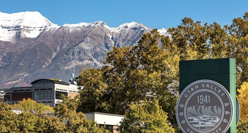 University seal with campus and mountains in the background.