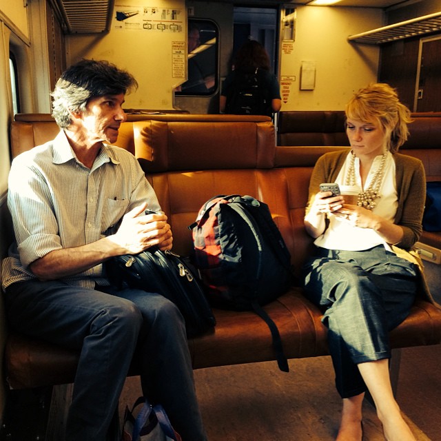 Chairs of departments of English and Philosophy discuss matters on the train during their commute home