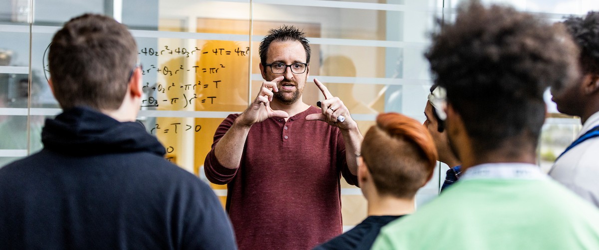 professor teaching a lecture filled with students