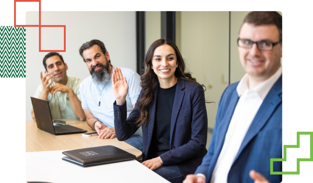 people sat around a table during a work meeting