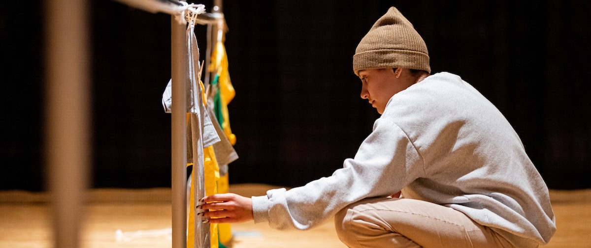 student working on the UVU Clothesline Project