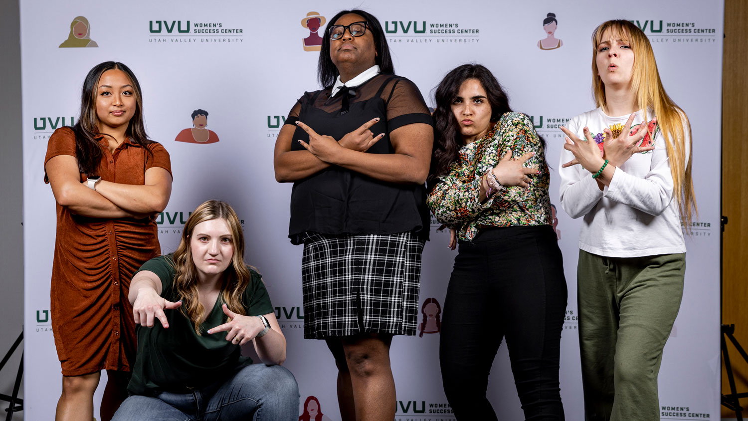 A group of women striking a peace sign pose