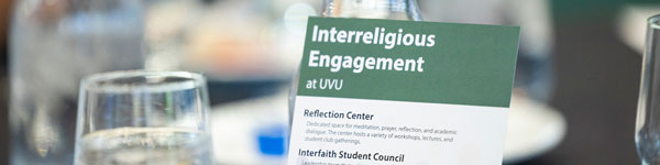 A card on a table that says Interreligious Engagement at UVU