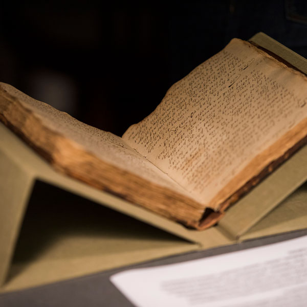 A antique looking book open to non-English characters