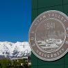 UVU institutional seal on signage with mountains in the background.