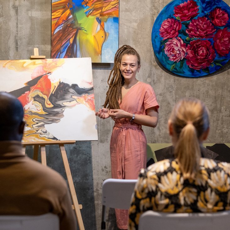 person standing in front of art painting