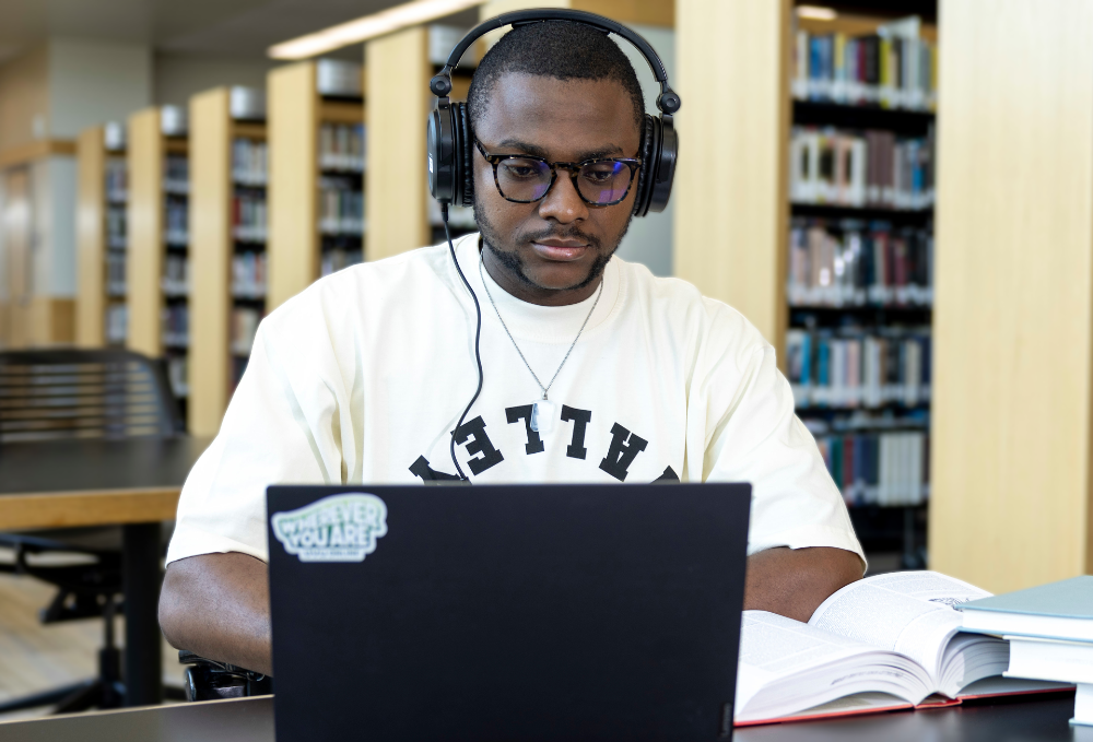 Student taking notes in the library