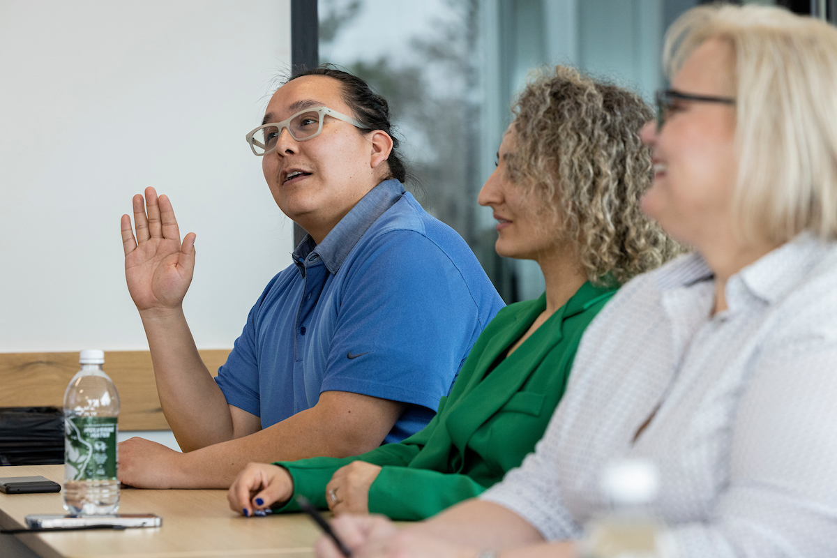 person raising their hand in a classroom