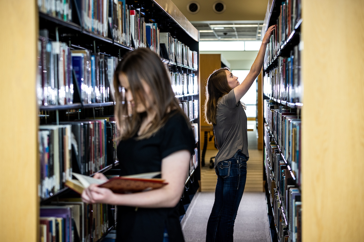 students choosing books in a library