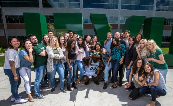 Large group of students standing in front of UVU sign.