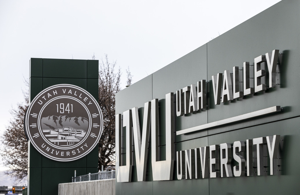 A photo of the UVU Orem campus entrance with the UVU logo and seal displayed.