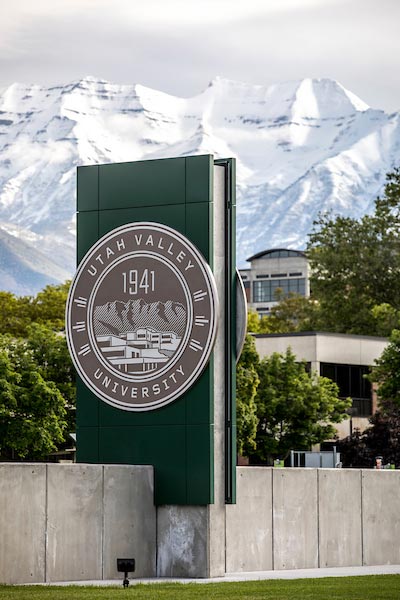 The UVU sign with snowcapped mountains in the background.
