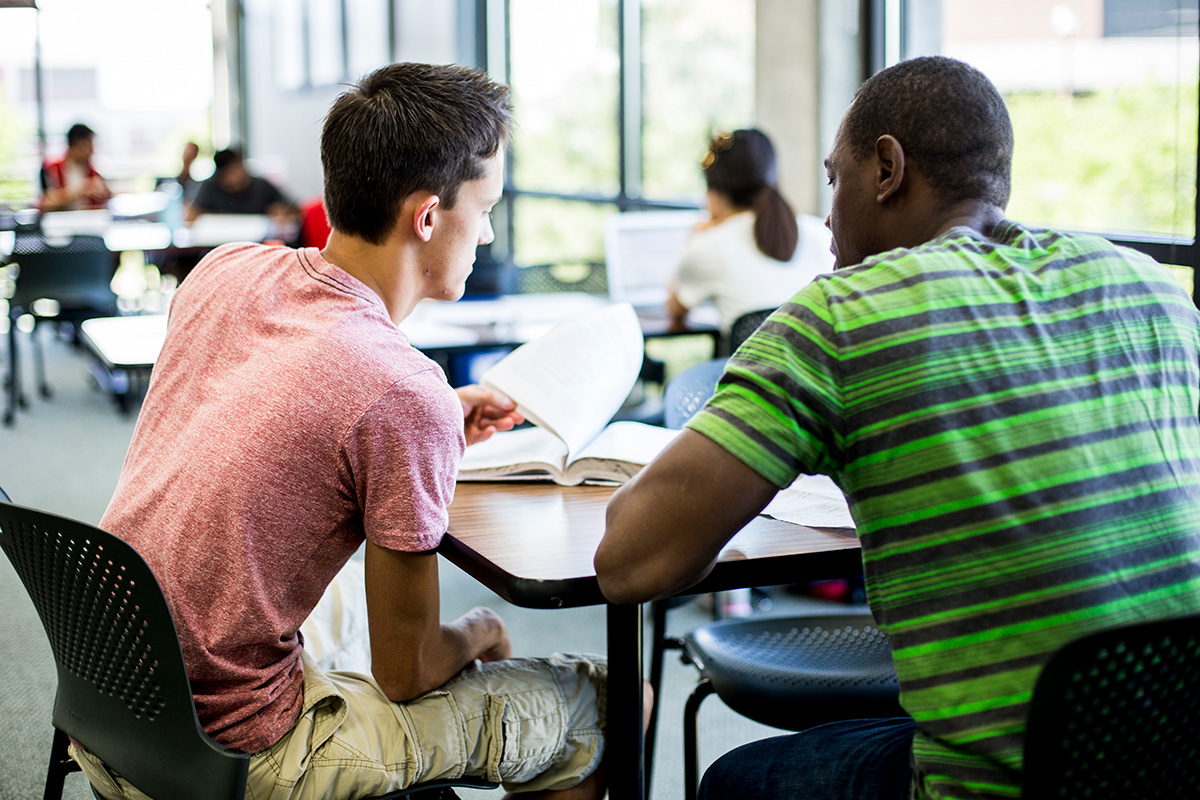 Two students sitting and studying.