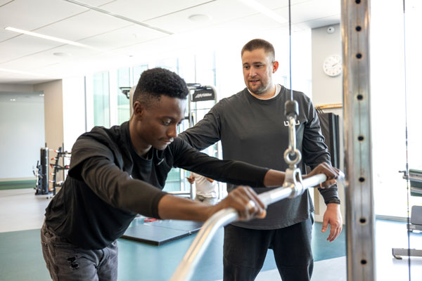 UVU personal trainer working with student