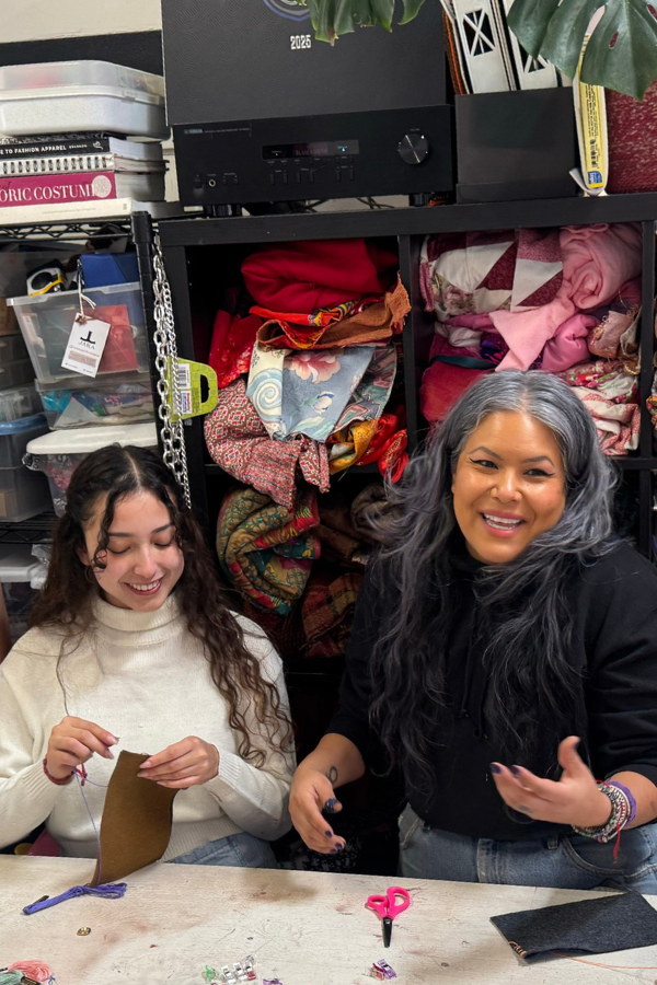 community partner shows students how to sew