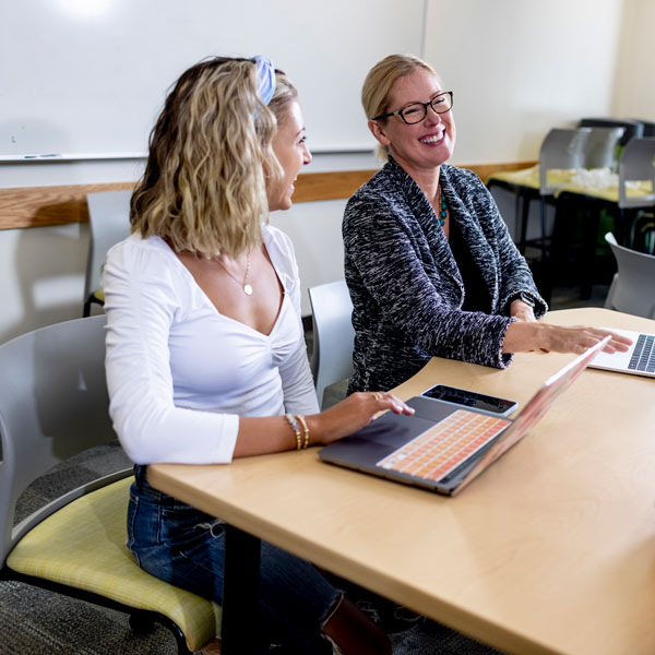 Two women collaborating through a service learning opportunity