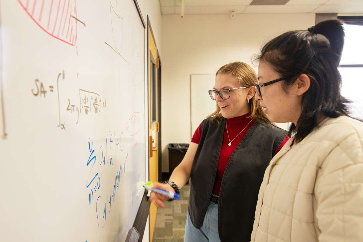 students looking at a white board