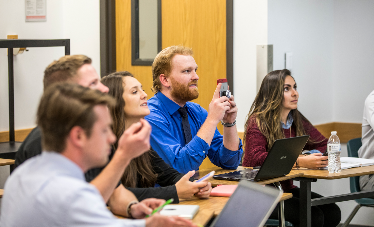 students sitting at desks listening to a lecture