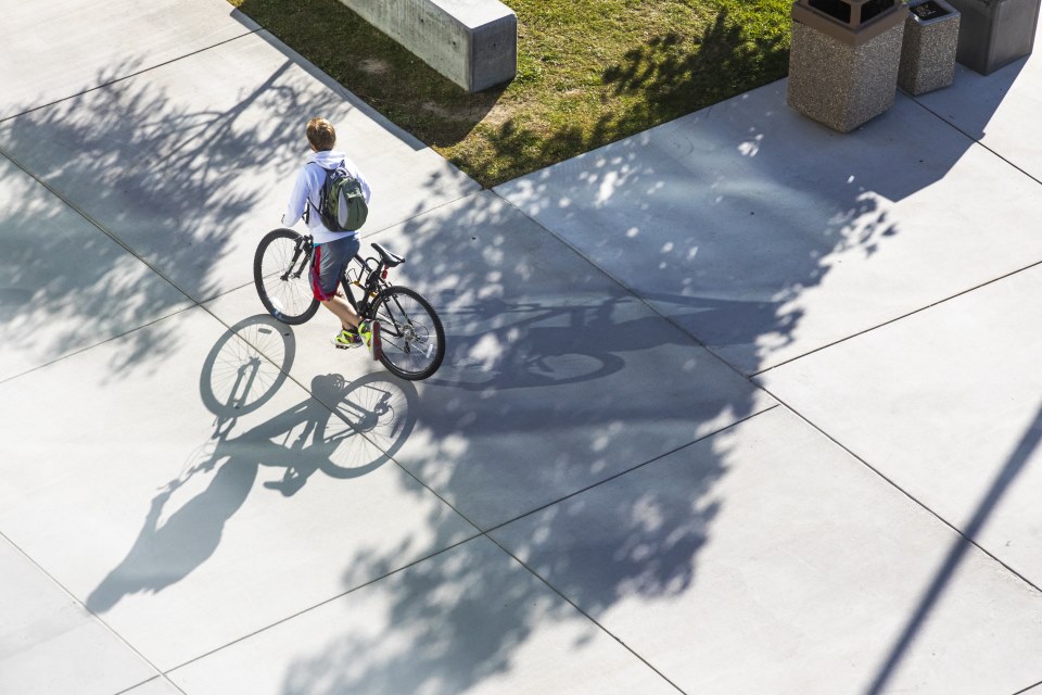 Student riding a bike around campus