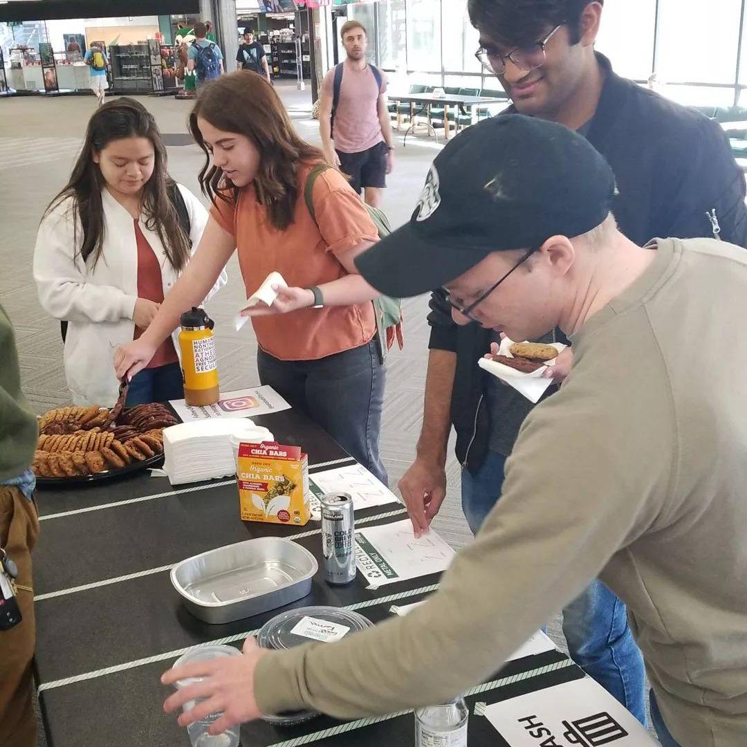 students at a table doing a waste sorting activity