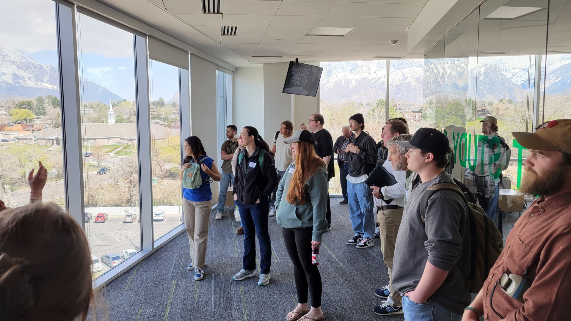 A group of people looking out a window in the Clarke Building