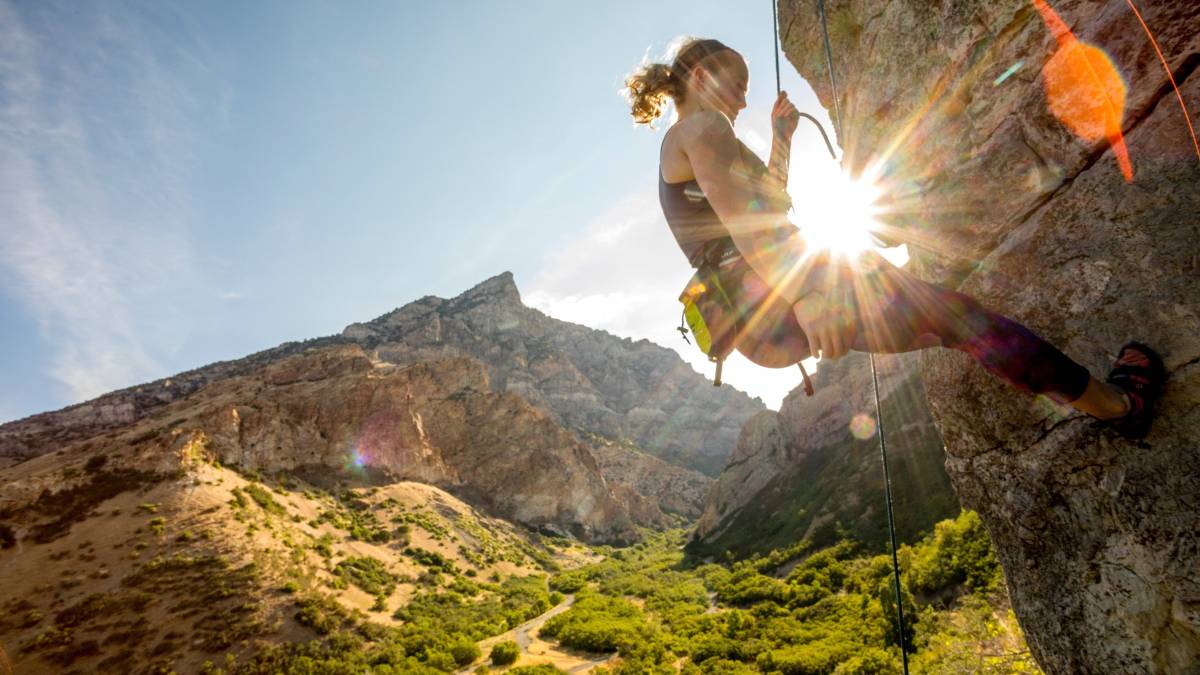 Person climbing with mountain in the background