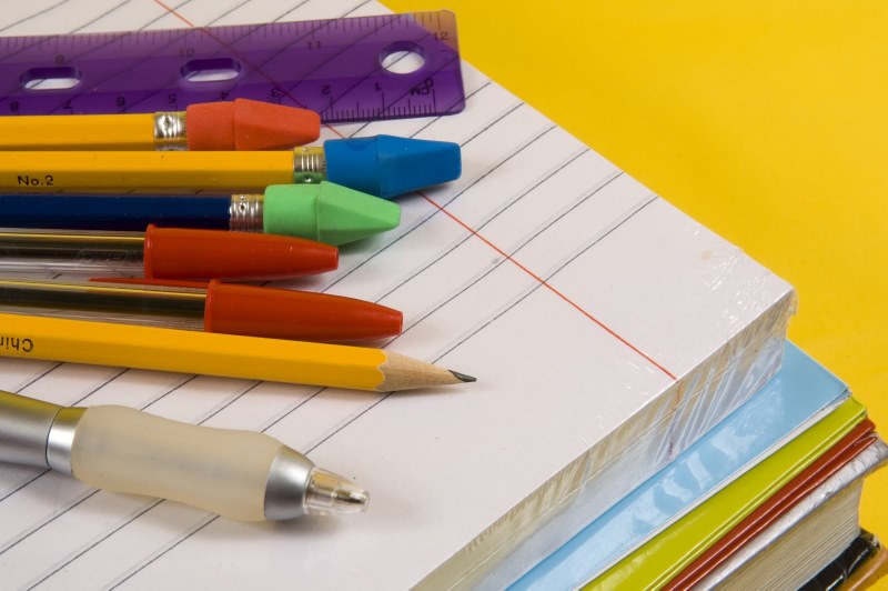 Stack of school supplies including pencils and paper