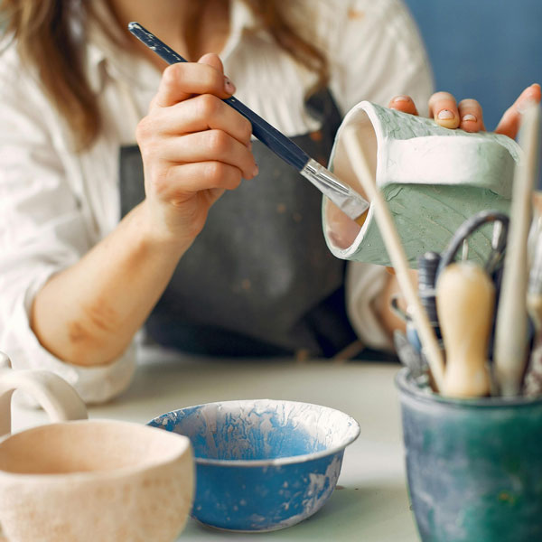 UVU student painting pottery at The Zone events