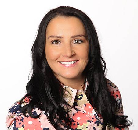 Photo of Erin Livingston a caucasian female with long dark hair wearing a floral print blouse