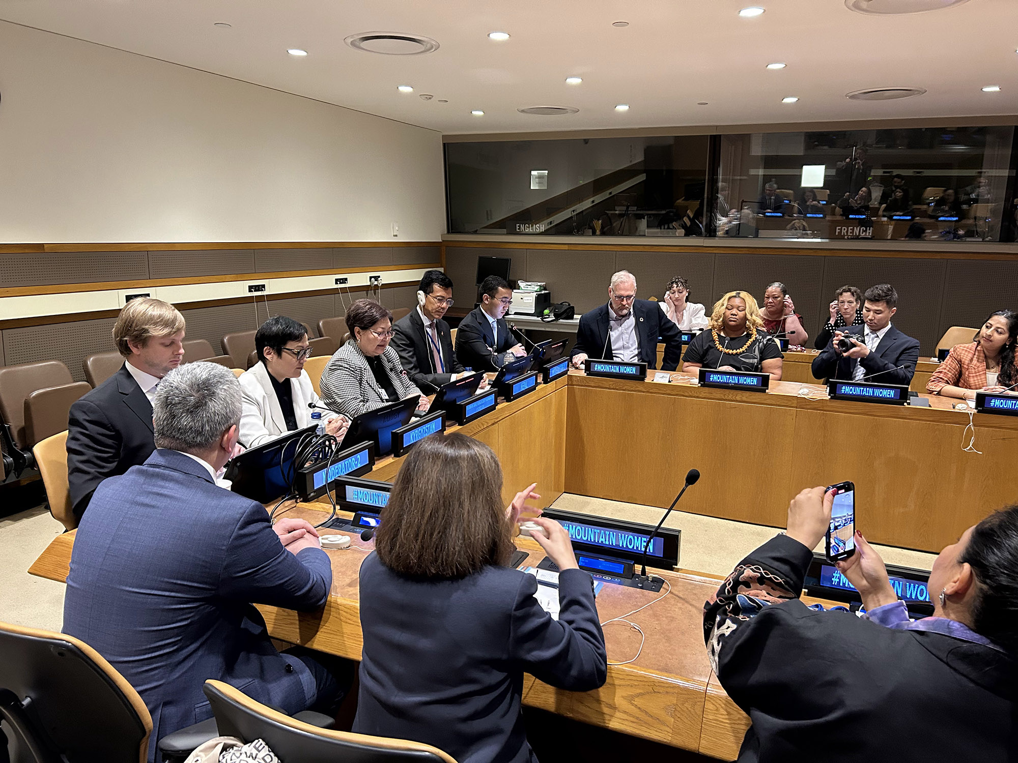 speakers at tables at the United Nations